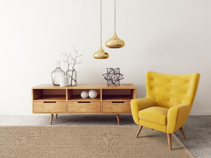 Photo of yellow armchair on a Purstoff hasel brown sisal rug with felt backing.