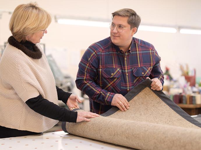 Photo of Mr. Hans-Philipp Schürholz checking a sewn sisal rug.