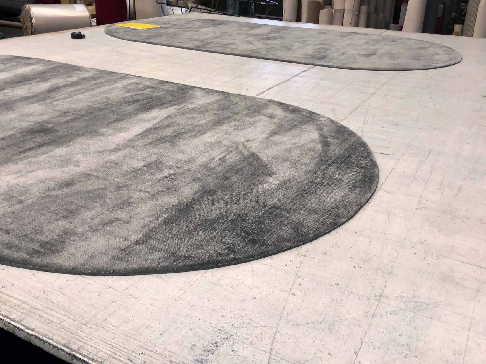 Photo from the production of two specially made rounded handwoven rugs.