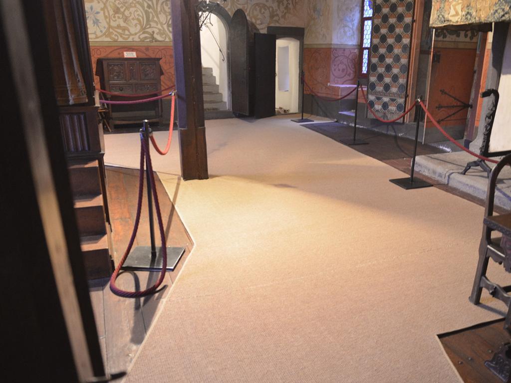 Photo of a large coconut carpet with many cutouts in Eltz Castle.