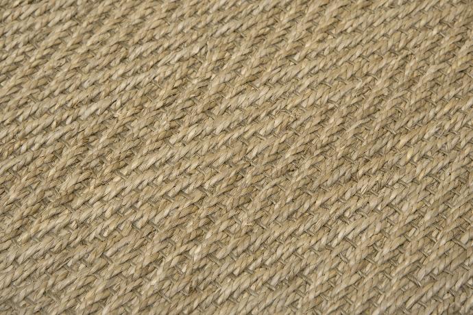 Close-up of a seagrass carpet in a herringbone weave.