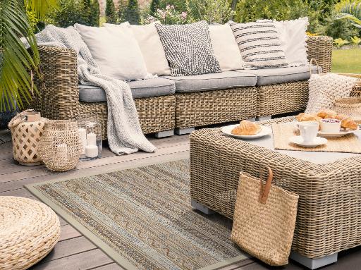 Photo of a Barbados sandy-beach outdoor rug on a porch.