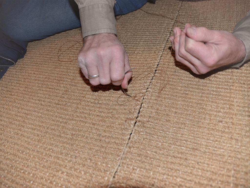 Photo of stitching of two coconut rugs.